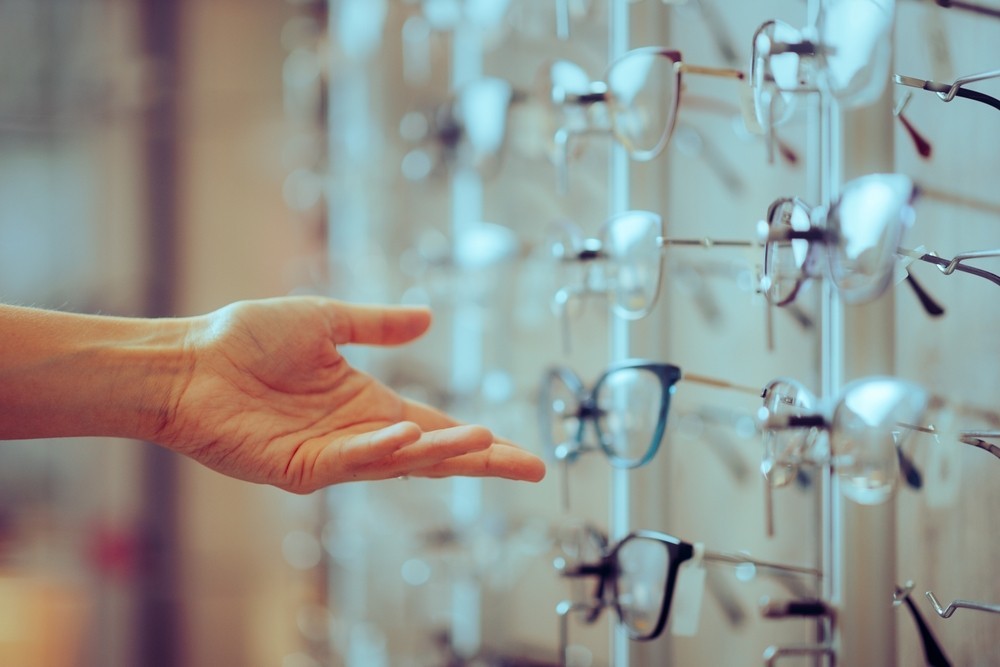 A person about to pick up glasses in an opticians