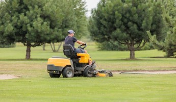 green mower on a golf course