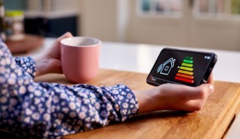 A person holding a smart meter screen