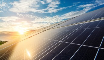 Solar panels with the sun reflecting off them