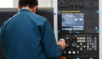 Man using CNC Lathe machine 