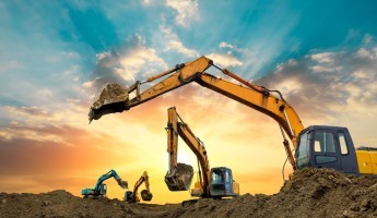 Multiple construction assets preparing a site