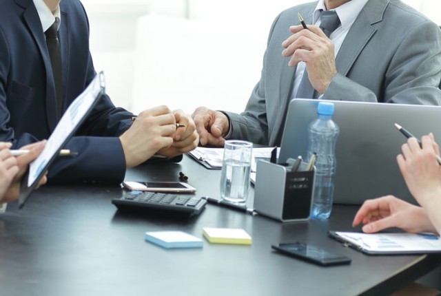 Manager and business group discussing financial documents