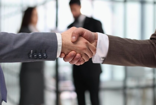 Close-up of business partners handshaking after successful agree