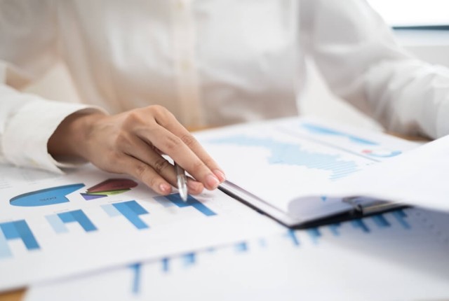 Woman looking at balance sheets