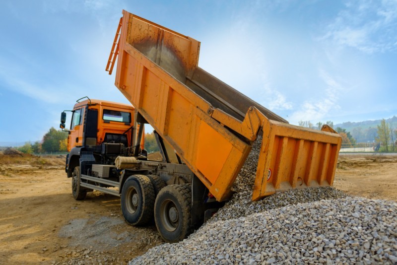dump truck releasing pebbles from the truck
