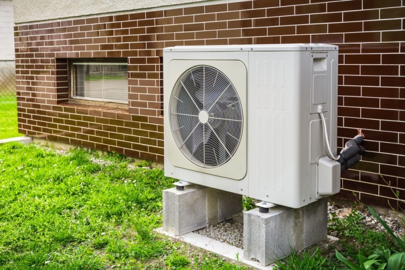 A heat pump next to a wall