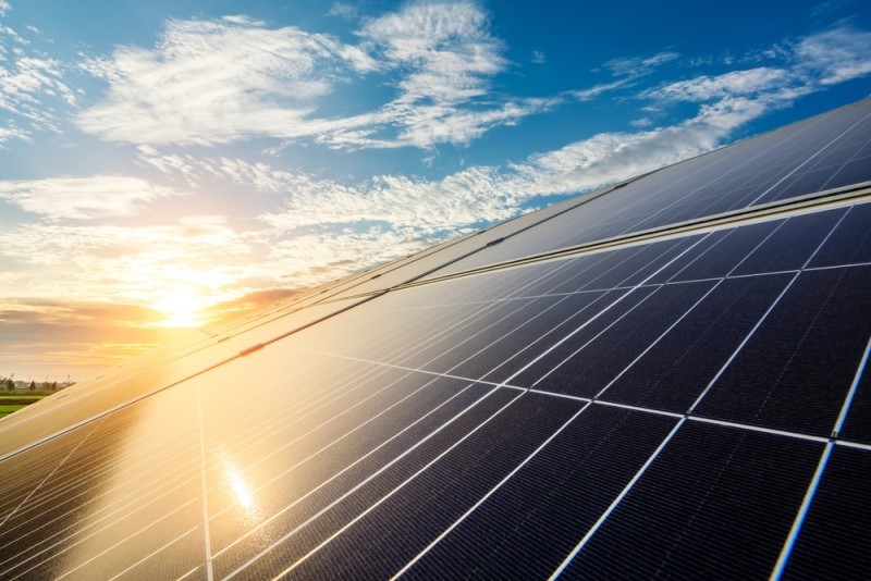Solar panels with the sun reflecting off them
