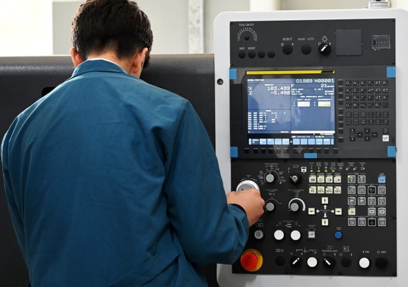 Man using CNC Lathe machine 